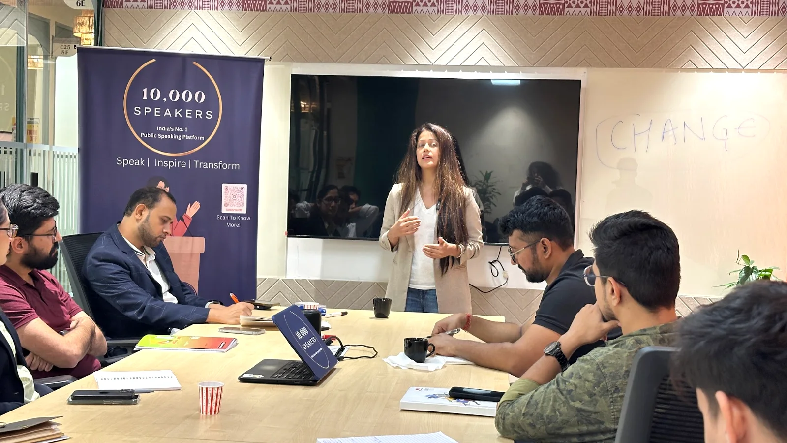 A participant speaking to the batch during a practice round in Gurgaon